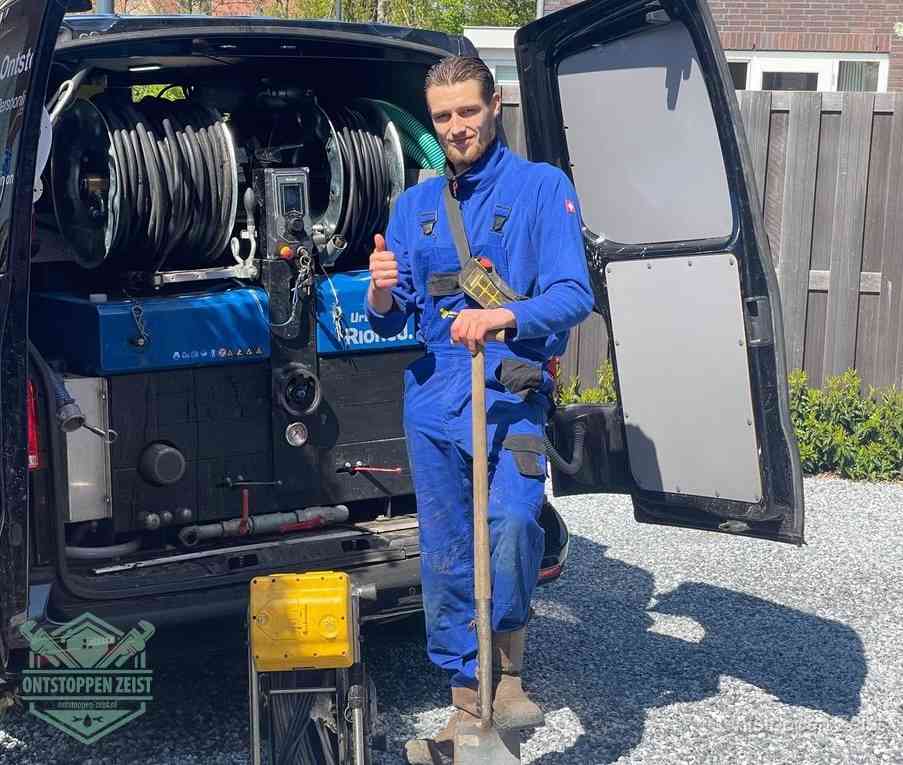 Een tevreden monteur met opgestoken duim naast de bestelbus, slim ingrijpen bespaart kosten bij een verstopte afvoer in Zeist