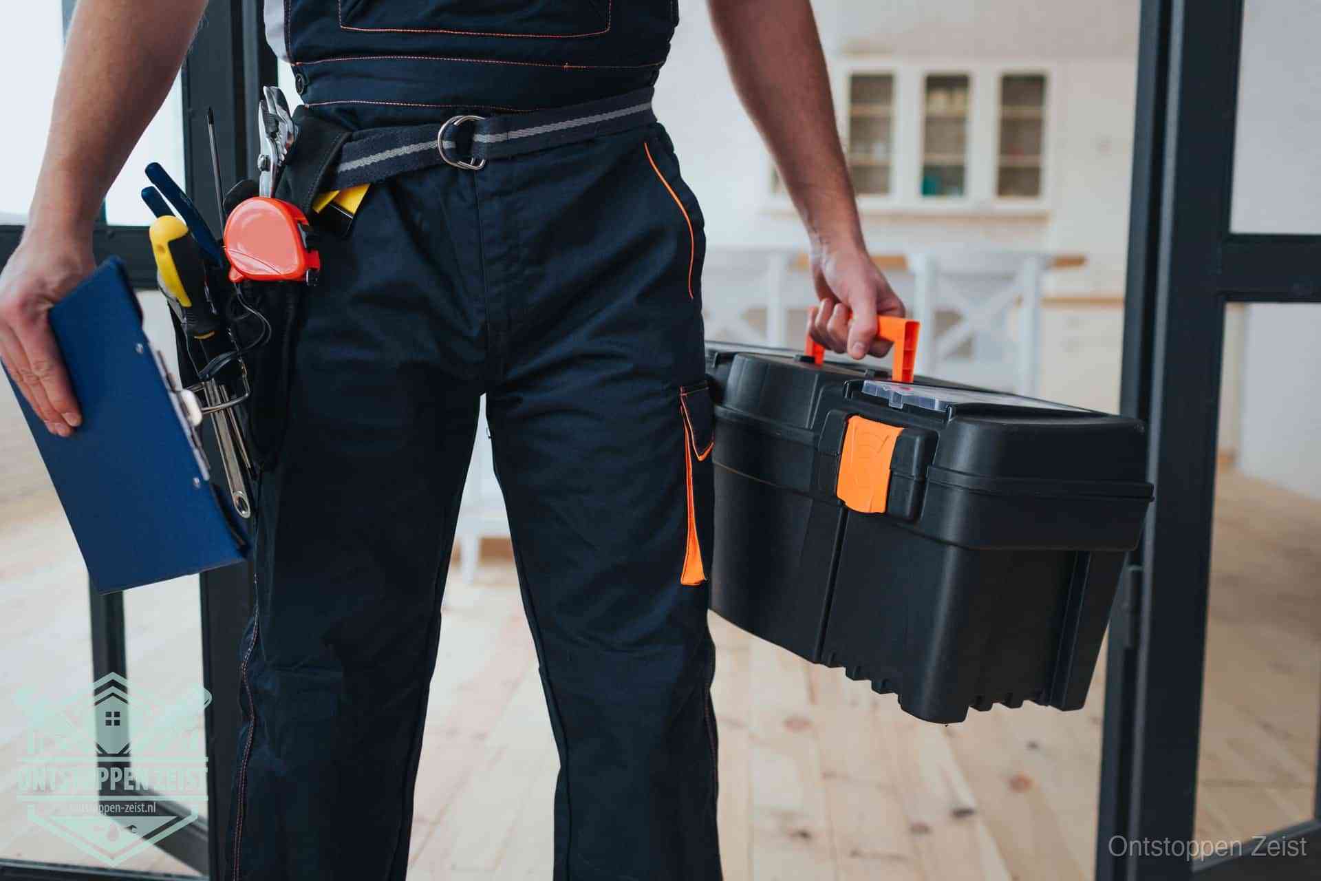 Een monteur met gereedschapsriem en klembord, klaar om een transparante prijs voor het wc ontstoppen in Zeist te geven Een monteur met gereedschapsriem en klembord, klaar om een transparante prijs voor het wc ontstoppen in Zeist te geven