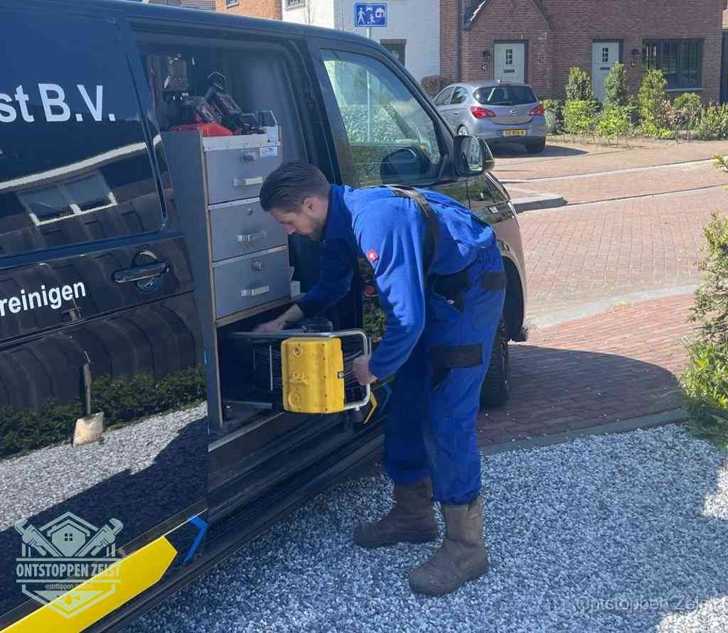 Een monteur pakt apparatuur uit de bedrijfsbus voor service aan huis, het moment om een professional in te schakelen voor een verstopte wc in Zeist Een monteur pakt apparatuur uit de bedrijfsbus voor service aan huis, het moment om een professional in te schakelen voor een verstopte wc in Zeist
