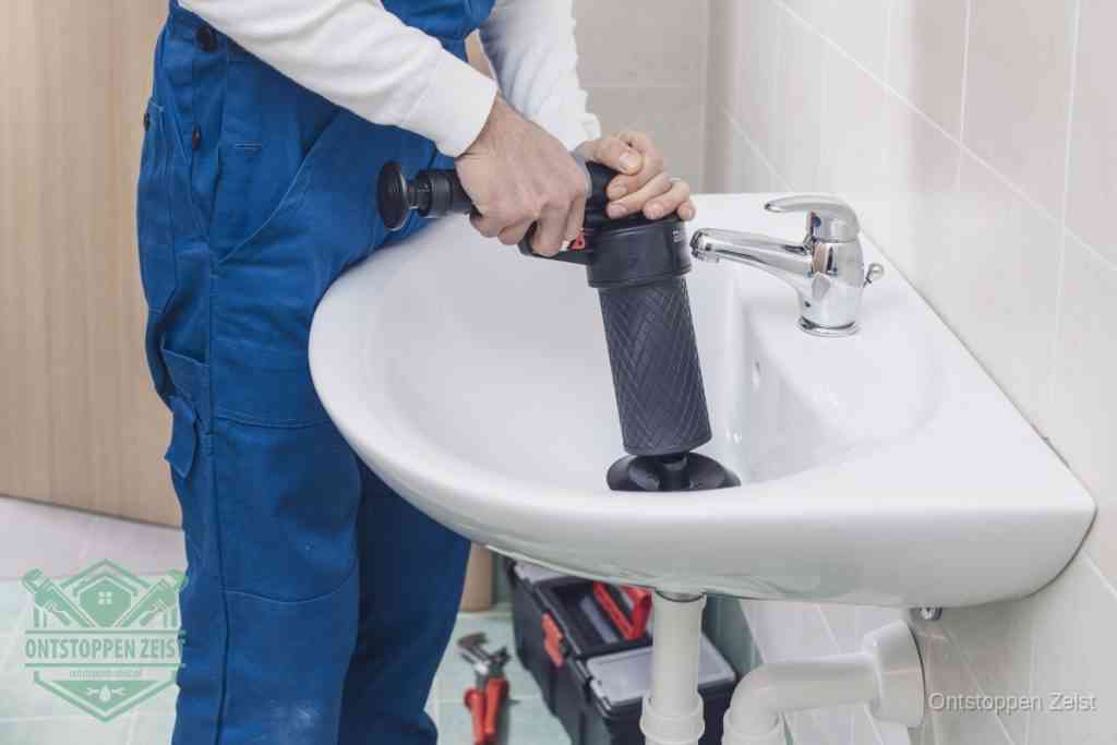Een te ruwe doe-het-zelf poging met een hand-pomp op de afvoer van een badkamer-wastafel, een van de veelgemaakte fouten bij afvoer ontstoppen in Zeist